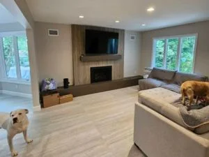 Light oak hardwood flooring in living room with fireplace and built-in cabinetry