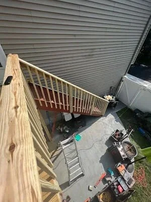 Newly constructed wood deck with pressure-treated lumber framing and railings