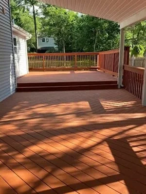 Composite deck with diagonal pattern and covered patio structure, warm wood tones