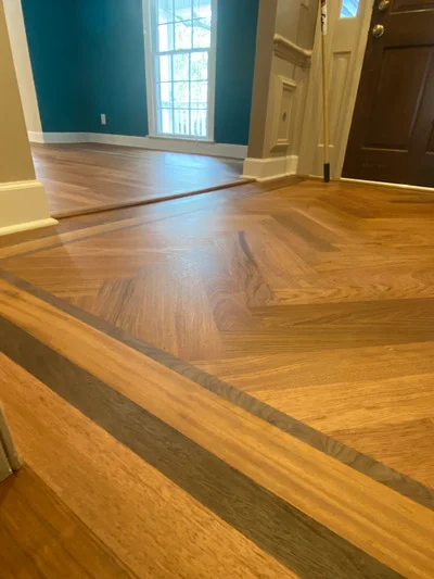 Oak hardwood flooring with dark wood inlay stripe and geometric pattern detail