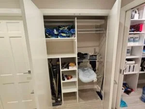 Organized closet with built-in shelving, white trim, and neatly arranged storage compartments